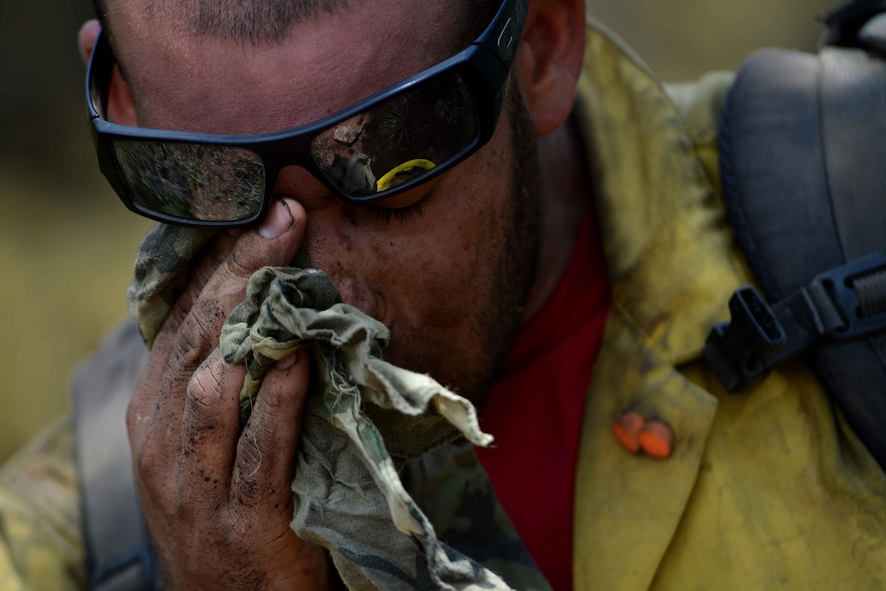 A forest firefighter overwhelmed by the challenges they face in suppression of wildfires